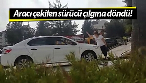 Aracı çekilen kadın, hırsını taşla aracının camı ve kaportasına zarar vererek aldı! (Videolu)