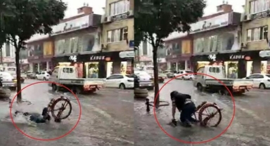 İnegöl'de sağanak etkili oldu; göle dönen yolda bisikletinden düştü